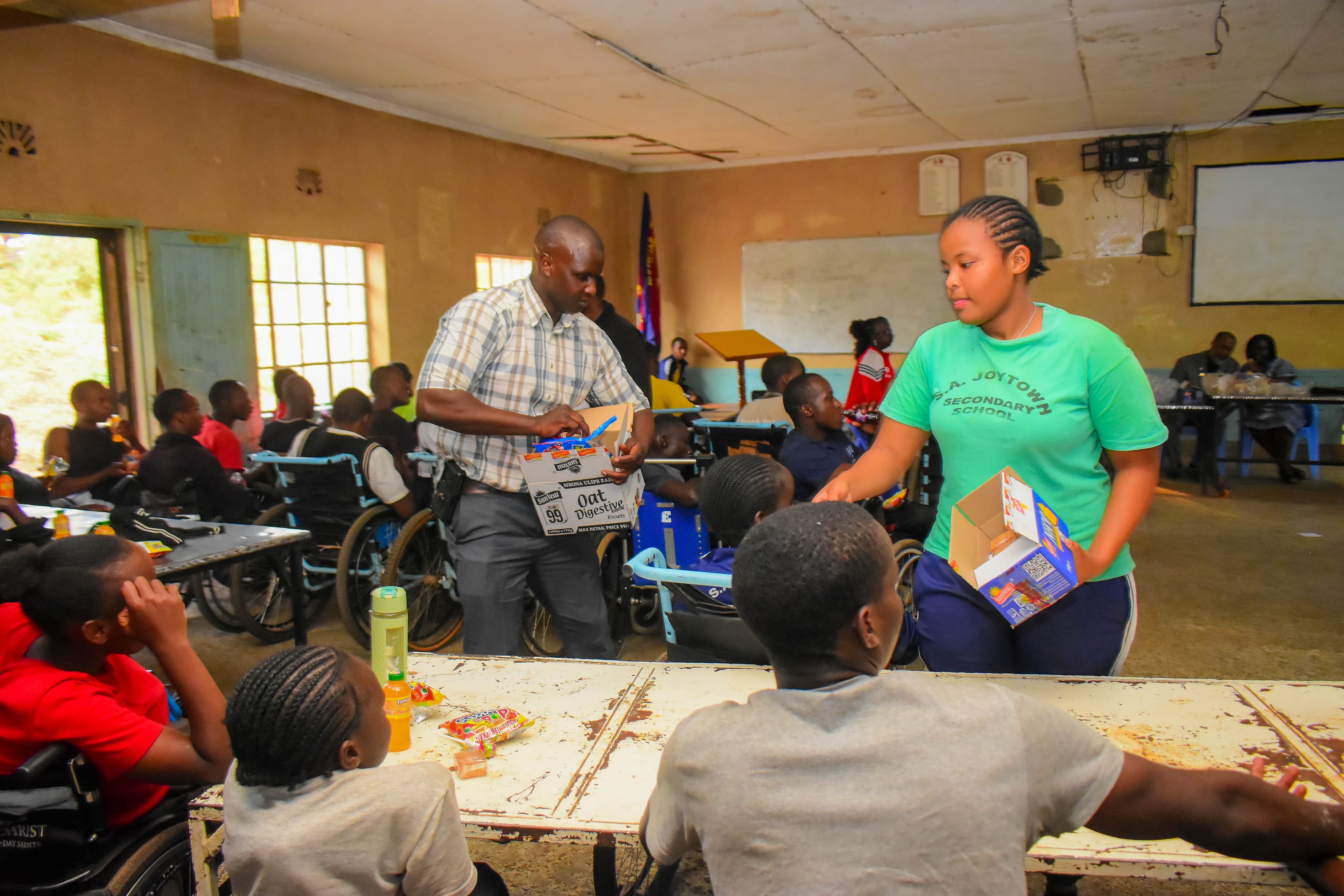 Volunteers sharing refreshments during an inclusive school outreach